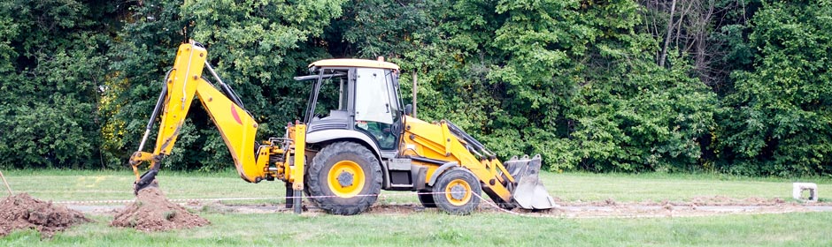 Affordable Septic Tank Systems - Bobcat digging ground surrounded by trees